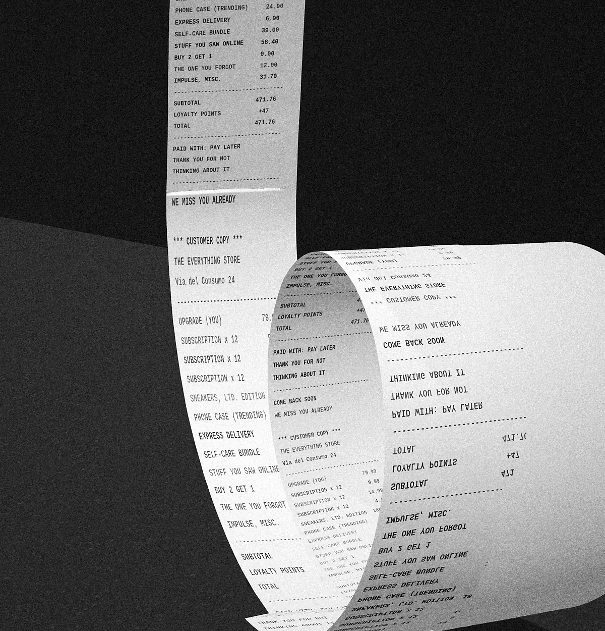 Black-and-white photograph of a very long shop receipt curling down onto the floor.